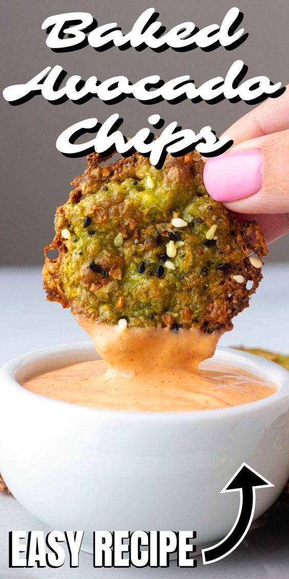 a hand dipping something into a bowl with the words baked avocado chips