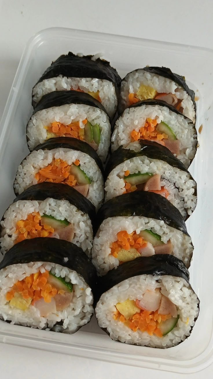 sushi rolls are arranged on a plate with chopsticks