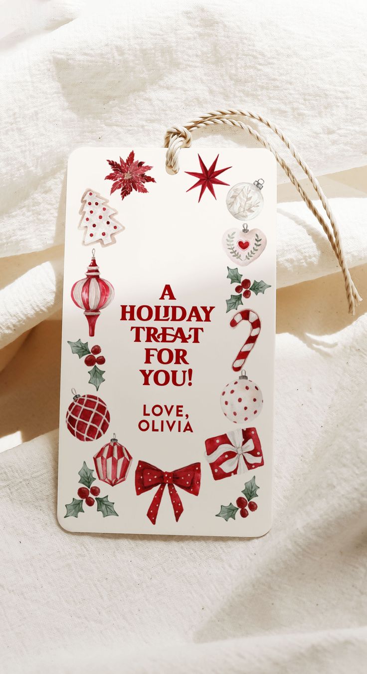 a holiday treat for you tag hanging on a white sheet with red and green decorations