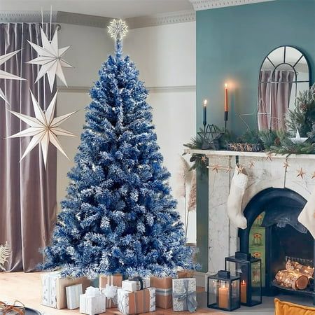 a blue christmas tree sitting next to a fireplace