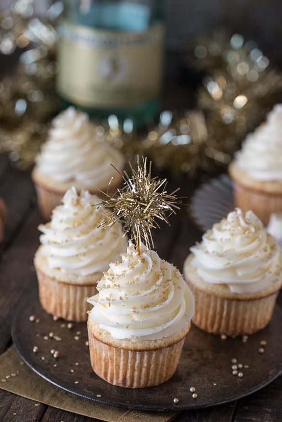 cupcakes with white frosting and a sparkler on top