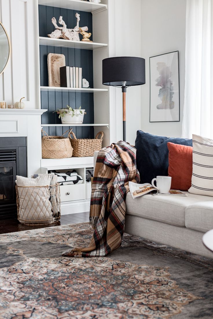 a living room with a couch, coffee table and fire place in the corner on instagram