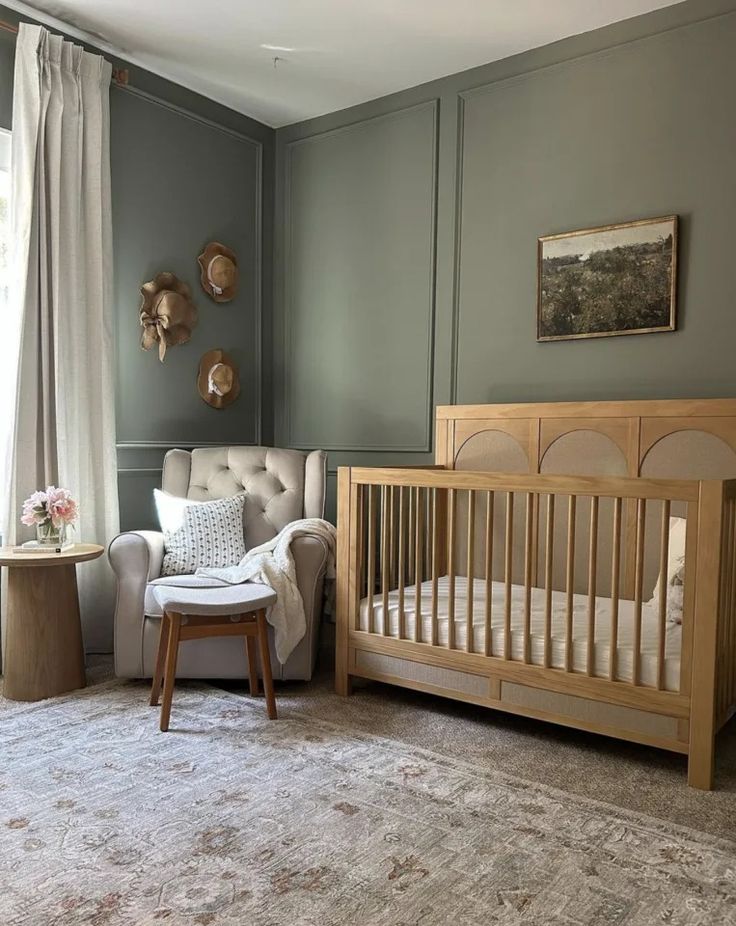 a baby's room with gray walls and furniture