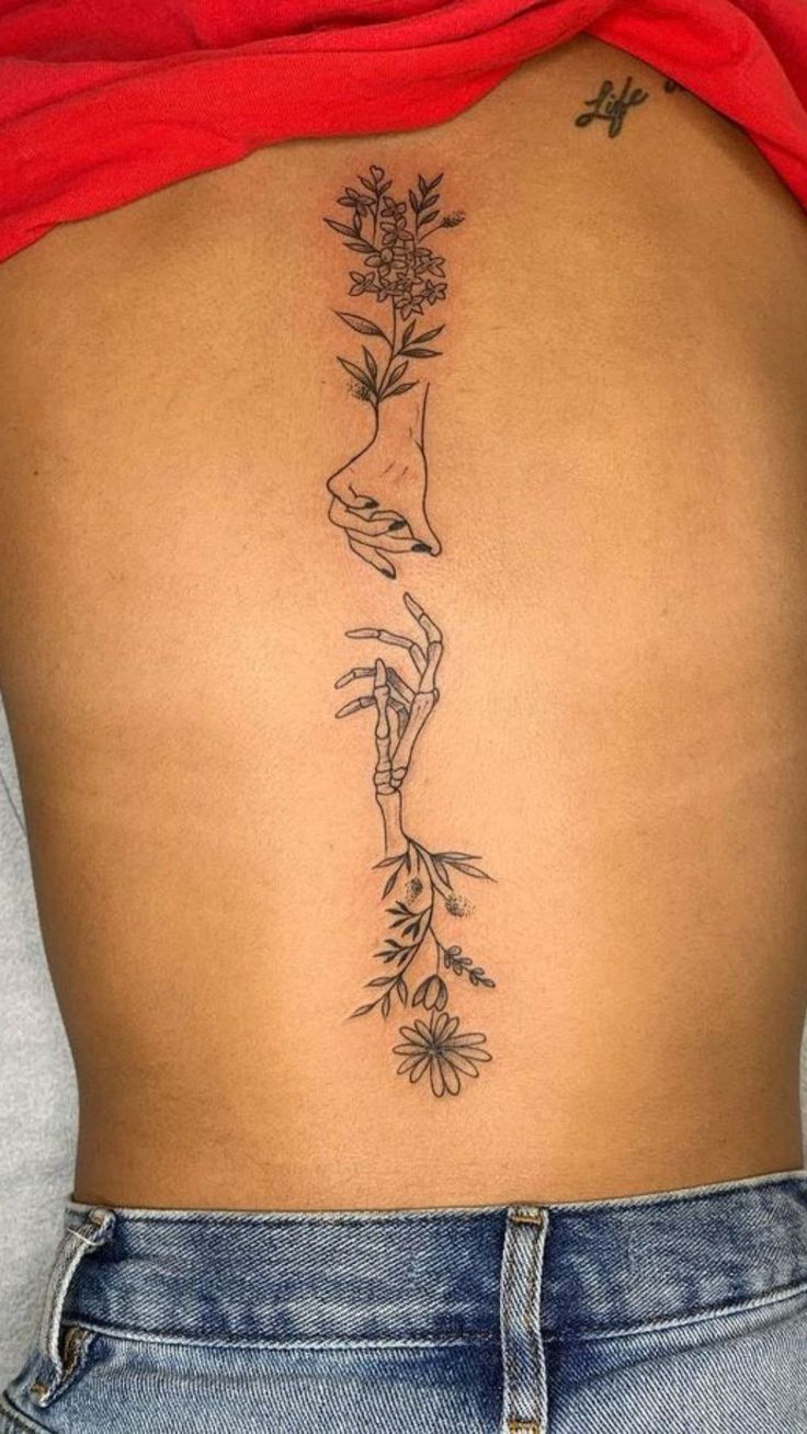 a woman's back with flowers on it and the bottom part of her body