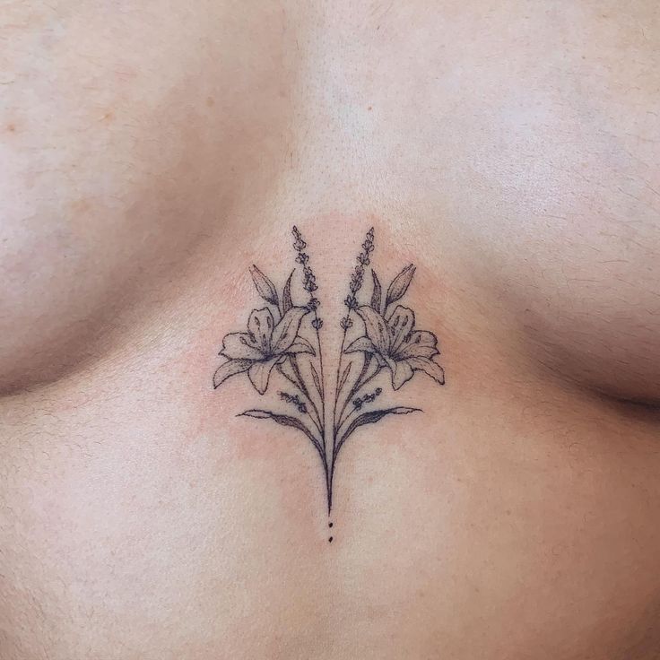 a close up of a woman's chest with flowers on it and the bottom part of her stomach