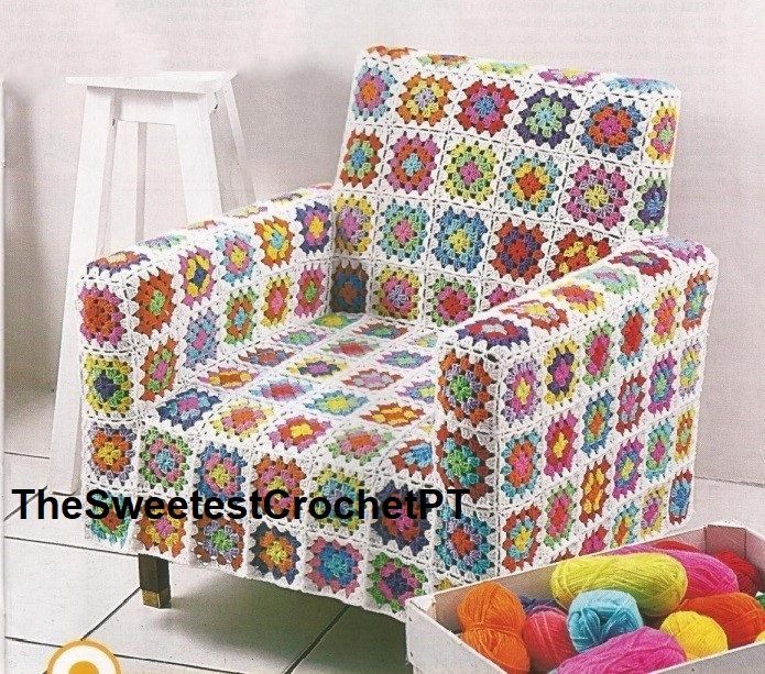 a crocheted chair and ottoman with balls of yarn in the box on the floor