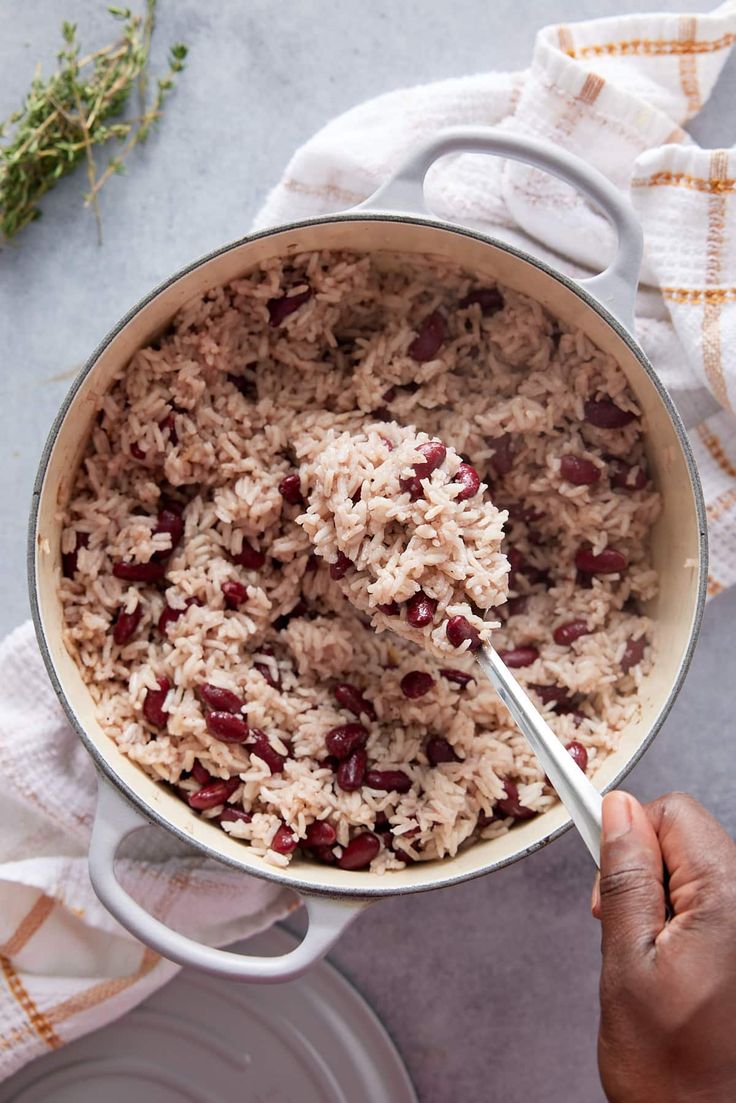 a pot filled with rice and beans on top of a table