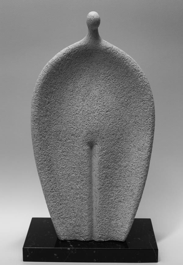 a large gray sculpture sitting on top of a black stand