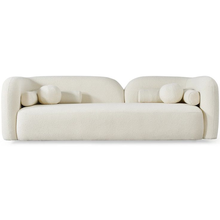 a white couch sitting on top of a white floor