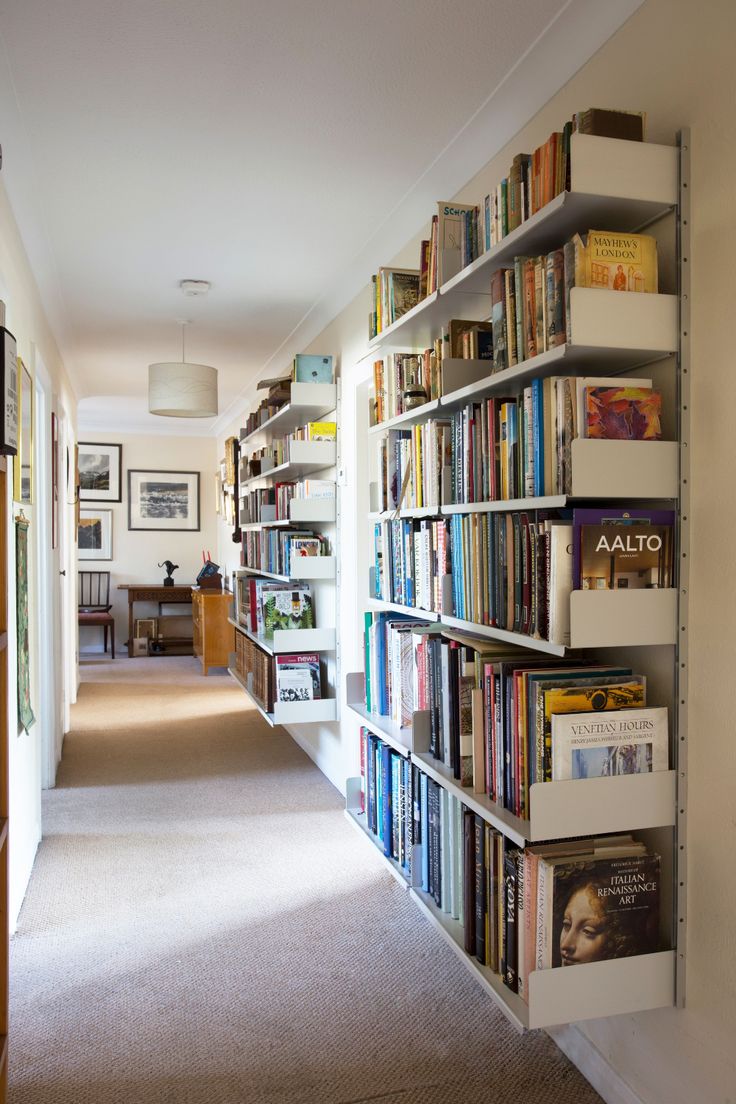 a long book shelf filled with lots of books