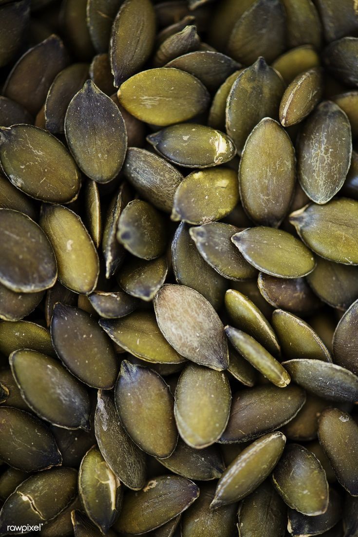 a pile of pumpkin seeds is shown close up