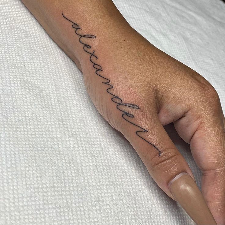 a person's hand with a tattoo that reads, love is in the air