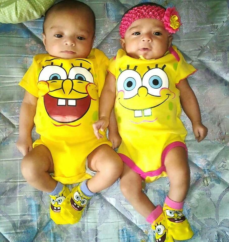 two babies dressed up as spongebobs sitting on a bed