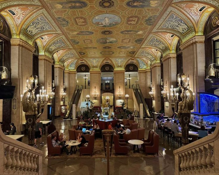 an ornately decorated lobby with chandeliers and tables