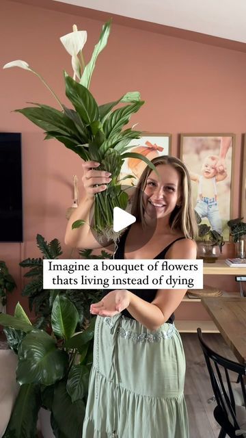 a woman holding a potted plant in her hand with the caption imagine a bouquet of flowers that's living instead of dying