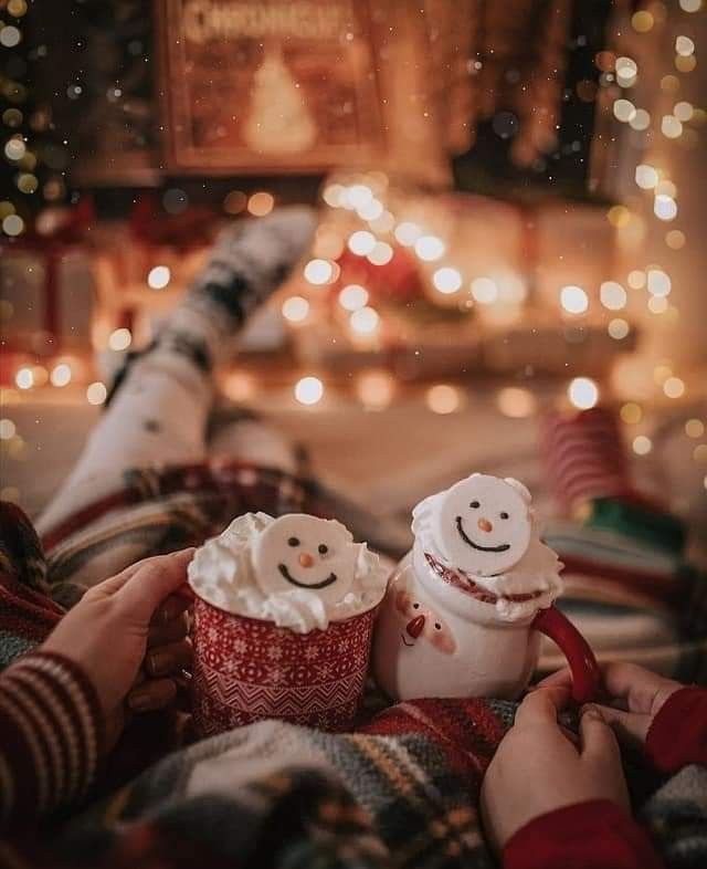 two cupcakes sitting on top of a blanket next to a person's feet