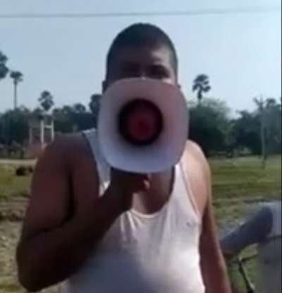 a man holding a white object in front of his face