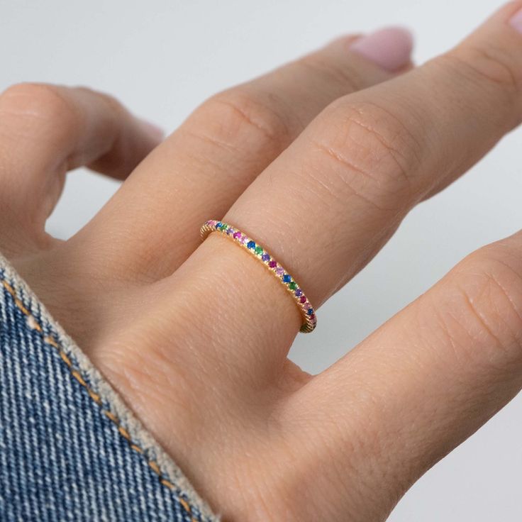 One of the biggest trends of the moment is rainbow, or multicolored jewelry! The colors are so vibrant, and truly matches with whatever you have on! Sweet, simple, and dainty eternity band. Perfect for a minimalist look, or for stacking. - - - D E T A I L S - - - * Made of 925 Sterling Silver * We use a THICK, DURABLE 14k Gold or Rhodium plating - for a piece that will last you years to come! * VERY HIGH QUALITY * Available in sizes 4, 5, 6, 7, 8, 9, or 10 * Features stones throughout the entire Rainbow Stackable Cubic Zirconia Rings, Rainbow Cubic Zirconia Stackable Rings, Rainbow Stackable Rings In Cubic Zirconia, Multicolor Open Crystal Ring, Trendy Multicolor Open Ring Jewelry, Adjustable Multicolor Crystal Promise Ring, Adjustable Multicolor Stackable Rings, Multicolor Open Ring For Promise, Multicolor Stackable Cubic Zirconia Rings