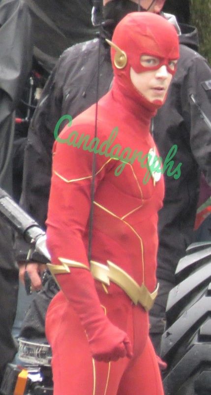 a man dressed as the flash is standing in front of some other men on motorcycles