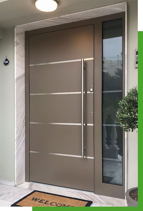 the front door to a building with a potted plant next to it and an entrance mat