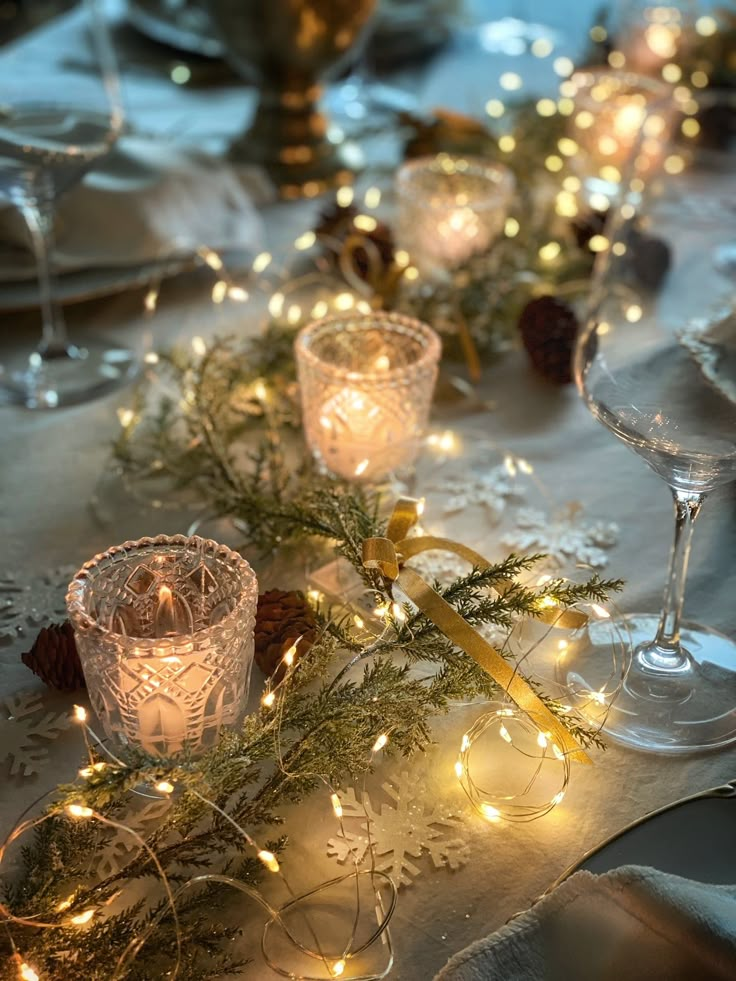 the table is set with candles and christmas decorations