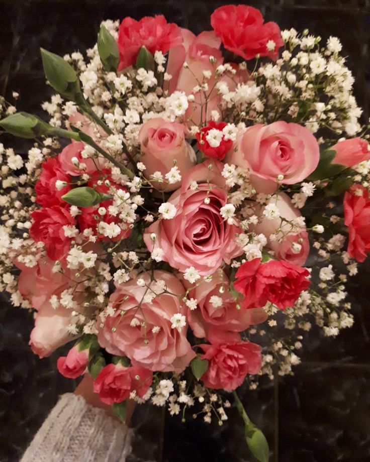 a vase filled with pink and white flowers