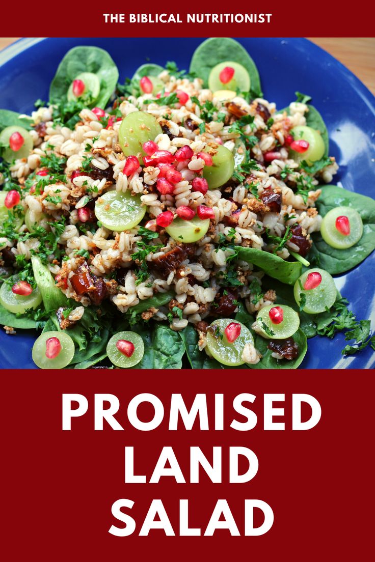 a blue plate topped with salad covered in cucumbers and pomegranates