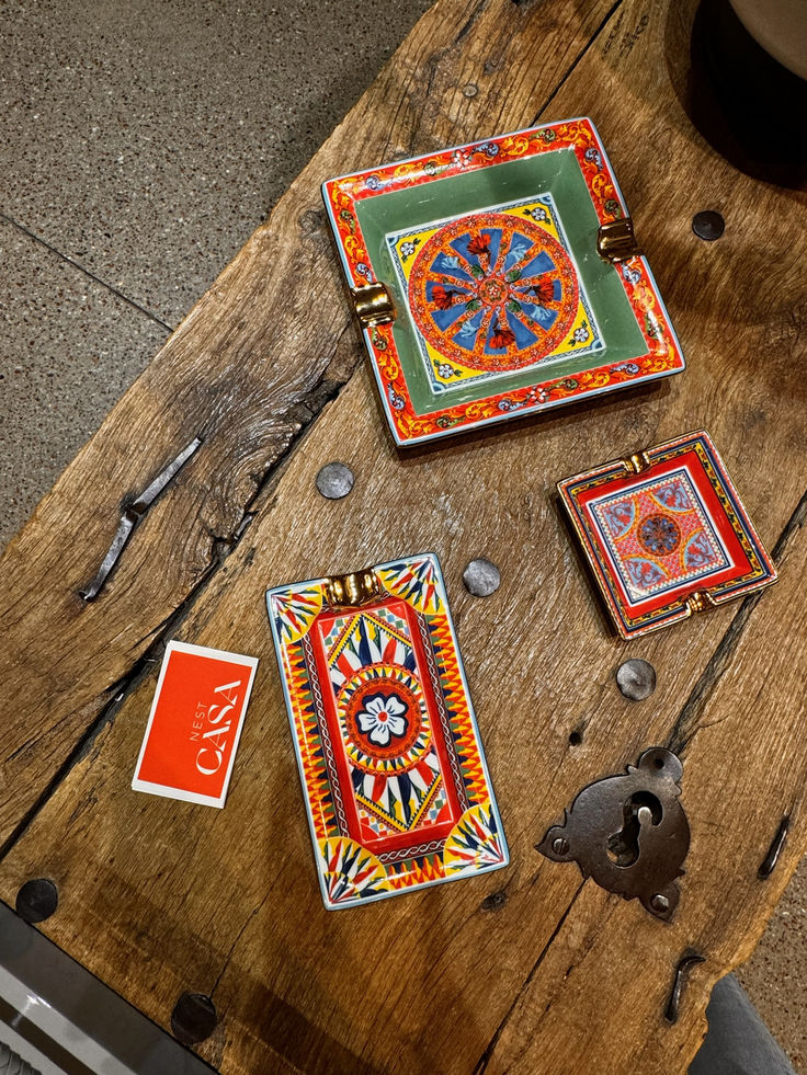 three colorful plates sitting on top of a wooden table