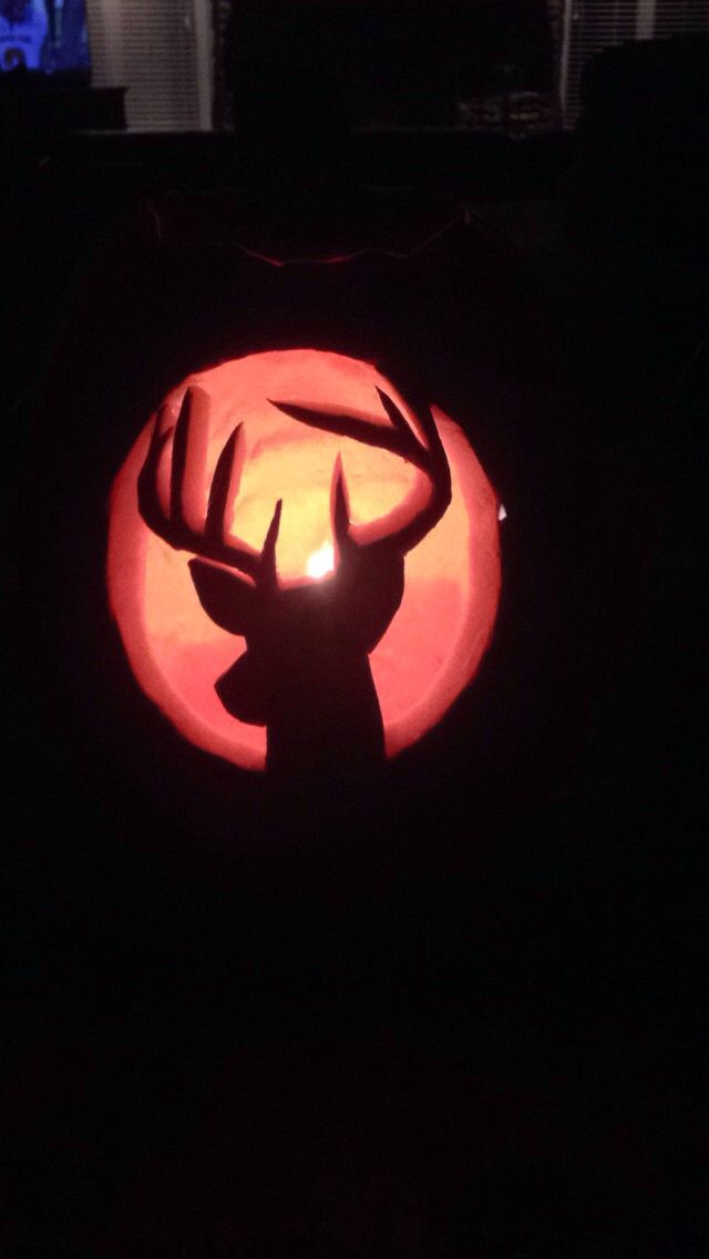 a deer head carved into the side of a pumpkin