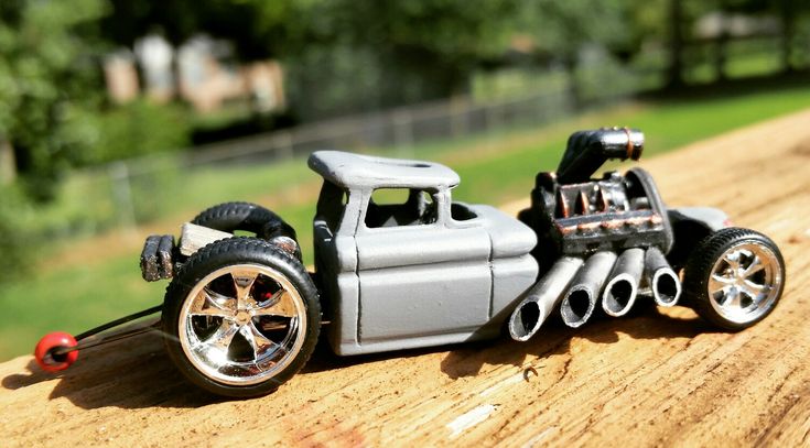 a toy car is sitting on a wooden table