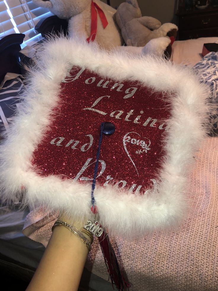 someone is holding a graduation cap made out of fur and beads with writing on it