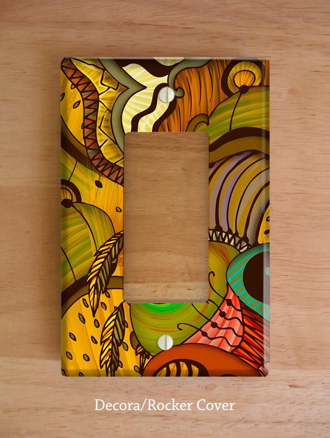 a decorative light switch plate cover on a wooden surface