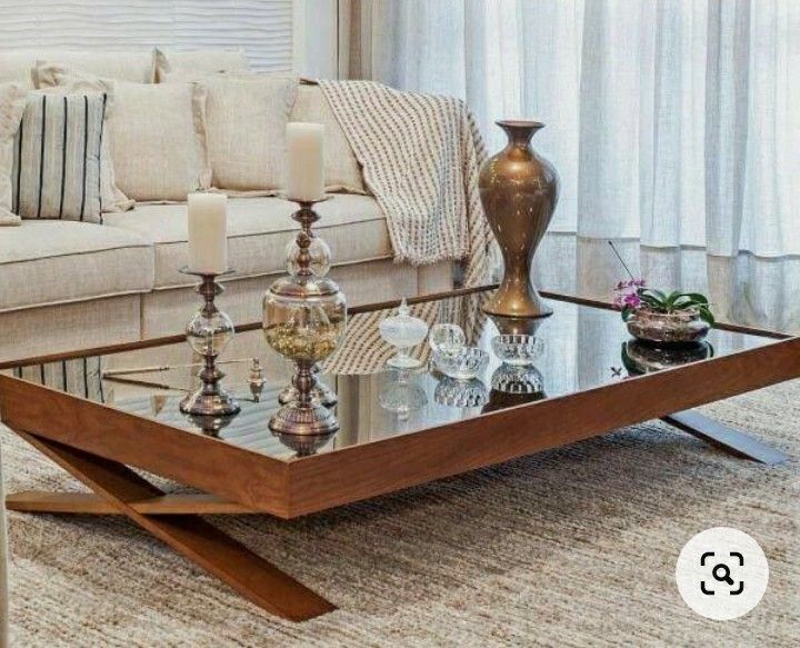 a coffee table with candles on it in front of a couch