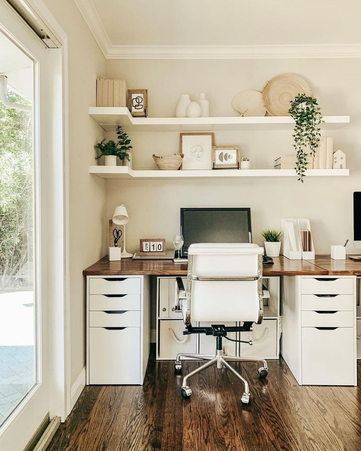 a desk with a computer on top of it in front of some shelves and drawers