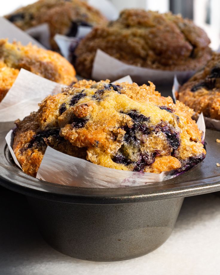 blueberry muffins sitting on top of a metal tray