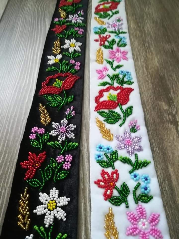 two different colored flowers on black and white ribbon