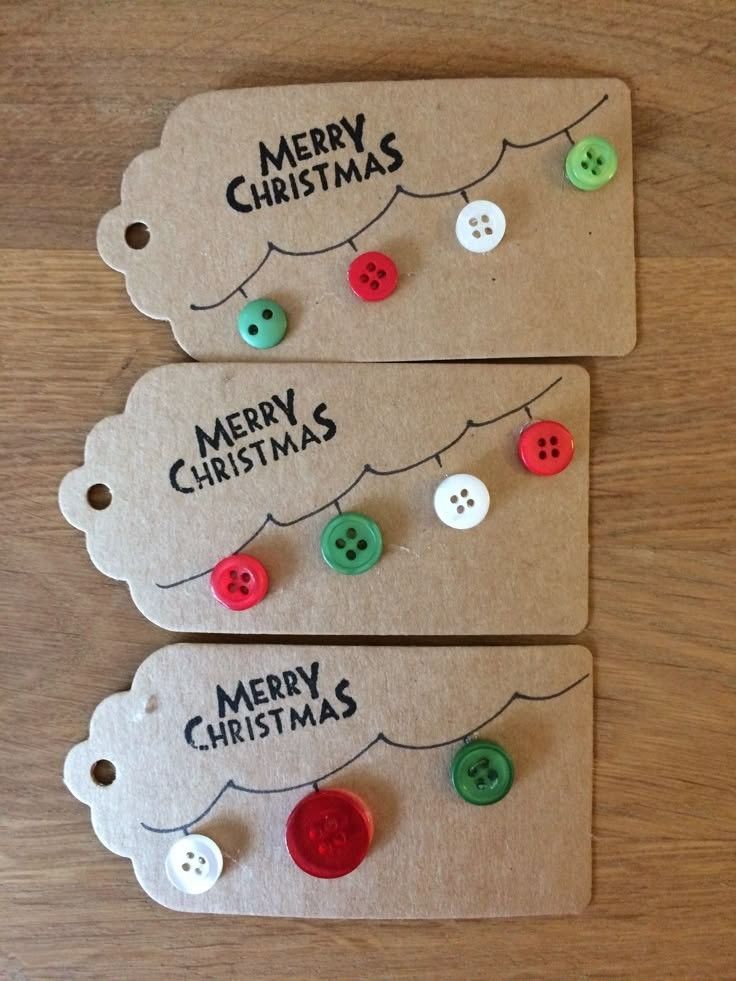 two tags with christmas buttons attached to them