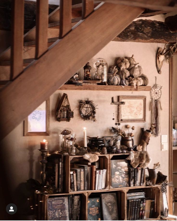 a book shelf filled with lots of books under a stair case