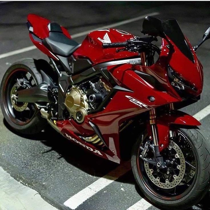 a red motorcycle is parked on the street