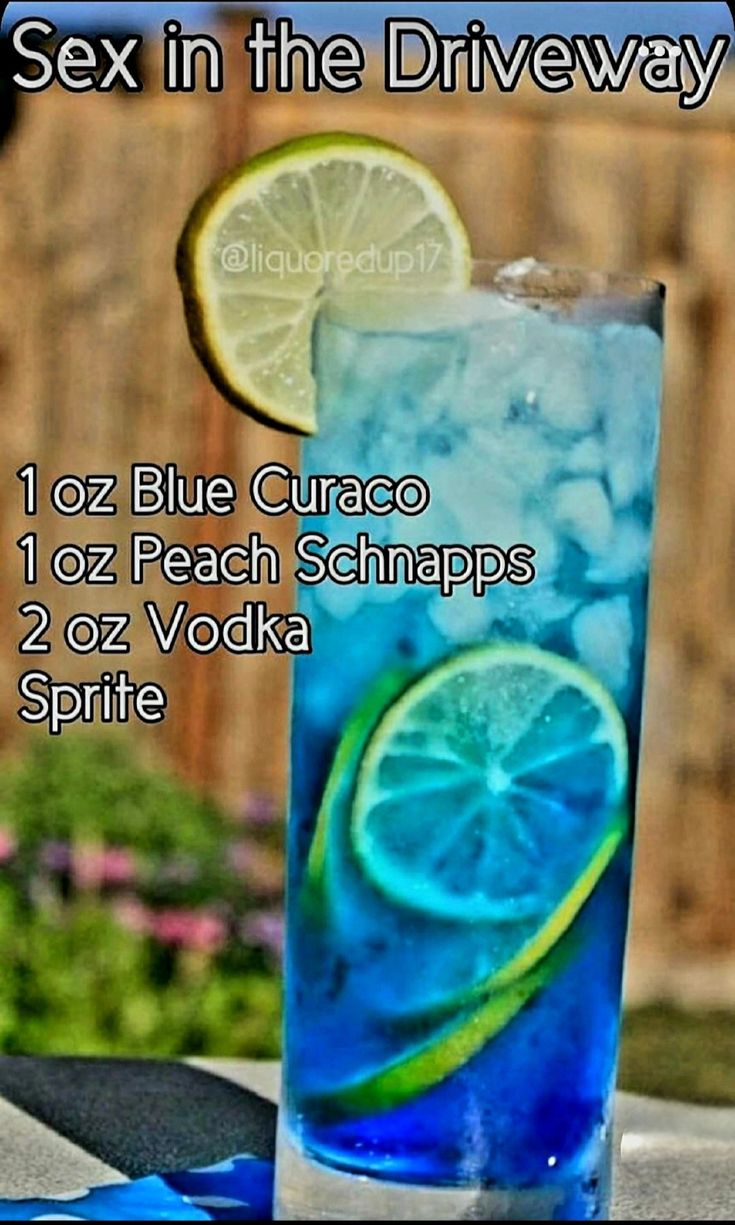 a blue curaco drink with ice and lemon slices