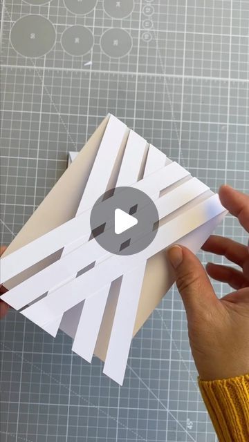 someone is cutting out an origami piece with scissors