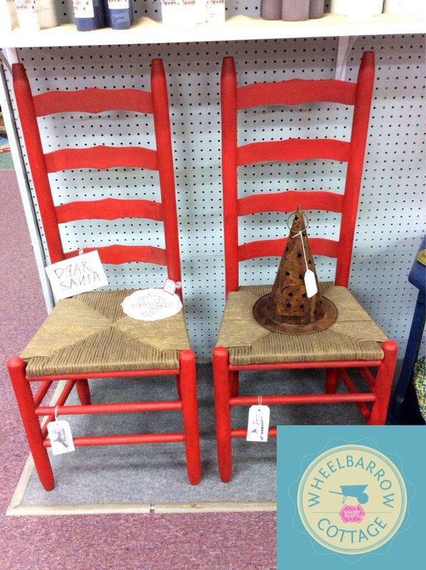 two red chairs sitting next to each other in front of a wall with signs on it