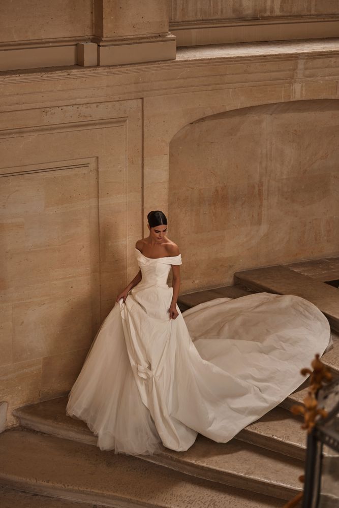 a woman in a white dress standing on some steps