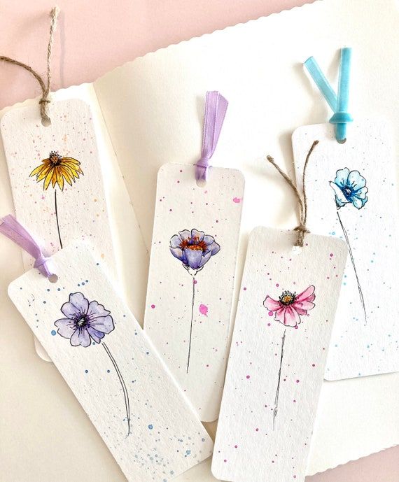 three tags with flowers painted on them