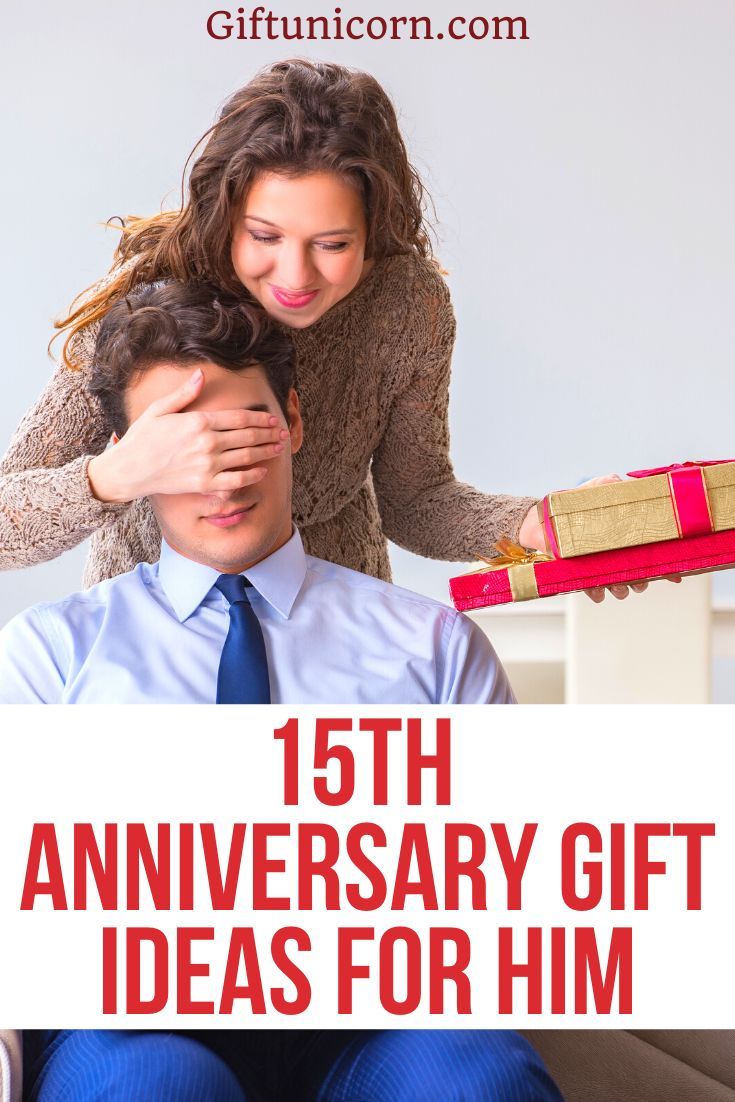 a man and woman sitting on top of a couch with presents in front of them