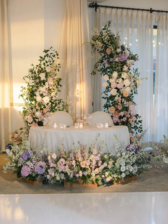 the table is covered with flowers and candles