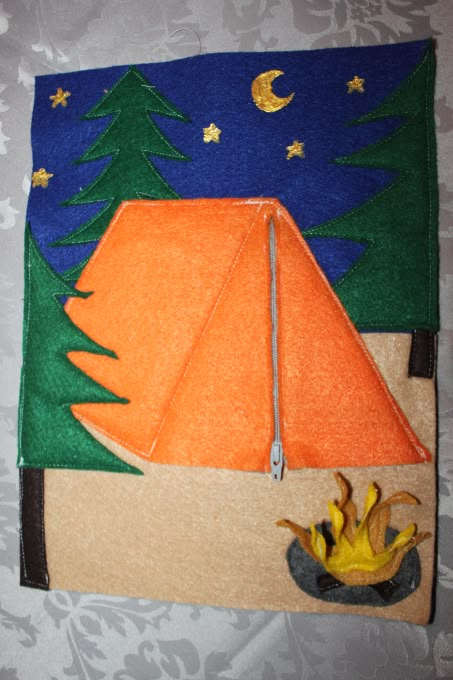 this is an image of a tent and campfire made out of felt on the wall