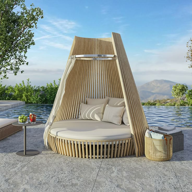 an outdoor day bed next to a pool with water and trees in the back ground