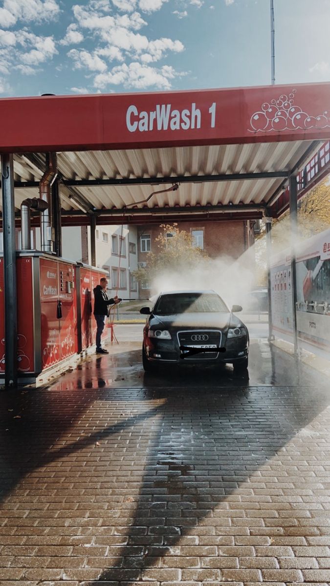 a car is parked in front of a gas station with steam coming out of it