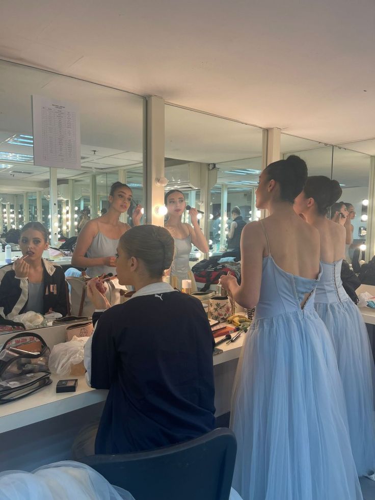 a group of people standing in front of a mirror